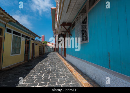 A curved, narrow and colorful cobblestone street in Guayaquil, Ecuador. Stock Photo