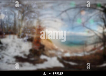Blurred panorama of the winter landscape by the sea with trees, snow on the ground. Background image. Stock Photo