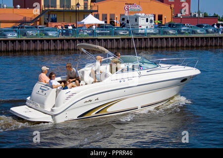 Family riding in a luxury inboard Sea Ray speedboat watercraft in the Duluth Harbor near Canal Park. Duluth Minnesota MN USA Stock Photo