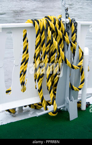 Decorative heavy duty yellow and black utility rope used to moor the excursion paddle boats on the St Croix River. Taylors Falls Minnesota MN USA Stock Photo