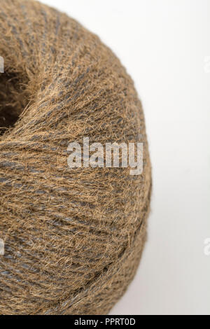 Natural tarred sisal garden twine / string. Great macro of individual fibres making up the twine. Metaphor 'How long is a piece of string?' Stock Photo