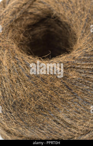 Natural tarred sisal fibre garden twine / string. Great macro of individual fibres making up the twine. Metaphor 'How long is a piece of string?' Stock Photo