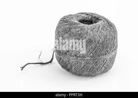 Natural tarred sisal garden twine / string. Grungy B&W conversion of PPRT3B. Metaphor 'How long is a piece of string.' Stock Photo