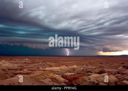 Stormy sky with dramatic shelf cloud and thunderstorm over the Painted Desert near Winslow, Arizona Stock Photo