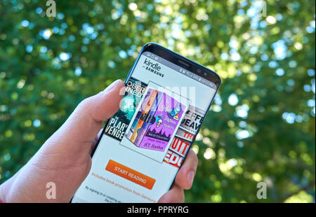 MONTREAL, CANADA - August 28, 2018: Amazon Kindle for Samsung android app on Samsung s8 screen in a hand. Stock Photo