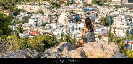Young girl on mobile phone with Athens in the background Stock Photo