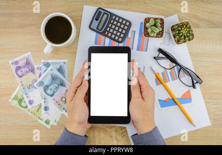 Buisnessman doing financial work at office desk with  essential tools items .Top view, business and finance concept. Stock Photo