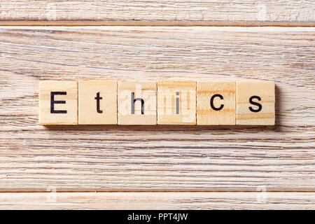 Ethics word written on wood block. Ethics text on table, concept. Stock Photo