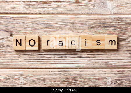No racism word written on wood block. No racism text on table, concept. Stock Photo