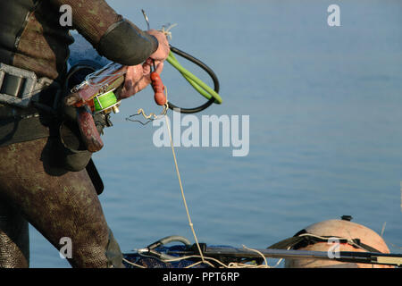 Crop view of scuba diver adult man on a seashore with spearfishing gear  (fins, speargun), space for text Stock Photo - Alamy