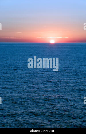 The sun sets over the Atlantic Ocean, seen from a cruise ship voyaging to Bermuda. Stock Photo