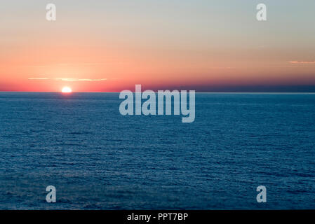 The sun sets over the Atlantic Ocean, seen from a cruise ship voyaging to Bermuda. Stock Photo
