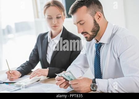 accountants counting dollar banknotes in office Stock Photo
