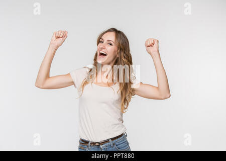 I won. Winning success happy woman celebrating being a winner. Dynamic image of caucasian female model on white studio background. Victory, delight concept. Human facial emotions concept. Trendy colors Stock Photo