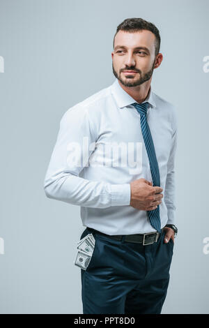 handsome financier with dollars in pocket isolated on grey Stock Photo