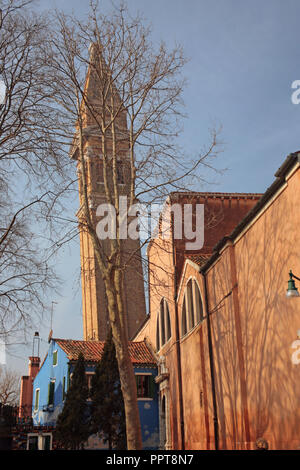 The leaning campanile of the Chiesa di San Martino, Buranoo, Venice, Italy on a sunny Winter's day Stock Photo