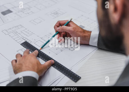 cropped view of architect working with blueprints, pencil and ruler Stock Photo