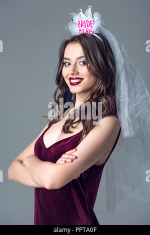 https://l450v.alamy.com/450v/ppta0f/smiling-future-bride-in-veil-for-bachelorette-party-with-crossed-arms-looking-at-camera-isolated-on-grey-ppta0f.jpg