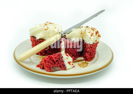 Red Velvet Cupcakes Cut with a Knife on a plate The two cakes at the rear are main point of fucus Stock Photo