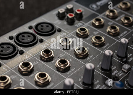rows of silver gold  audio input connectors, on a professional audio mixing console/ desk Stock Photo
