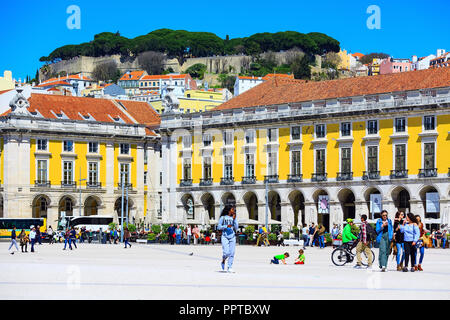 Lisbon, Portugal - March 27, 2018: Praca do Comercio or Commerce square, people and and Saint George Castle on the hill Stock Photo