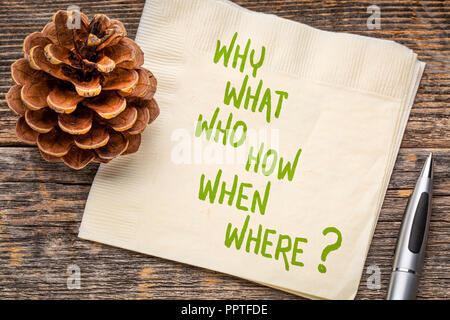 why, what, who, how, when, where brainstorming or decision making questions - handwriting on a napkin Stock Photo