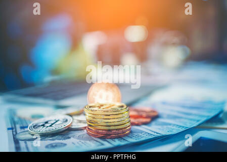 Physical version of Bitcoin (new virtual money) and banknotes of one dollar. Exchange bitcoin for a dollar. Conceptual image for worldwide cryptocurre Stock Photo