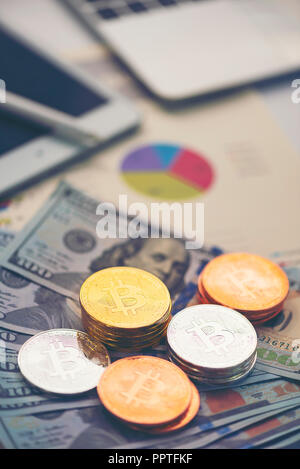 Physical version of Bitcoin (new virtual money) and banknotes of one dollar. Exchange bitcoin for a dollar. Conceptual image for worldwide cryptocurre Stock Photo