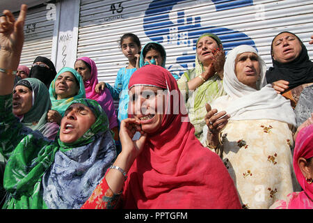 September 27, 2018 - Srinagar, Jammu and Kashmir, India - Women weep as protests escalate after the funeral of a civilian Saleem Malik in Srinagar the summer capital of Indian controlled Kashmir on September 27, 2018. Malik according his family members was shot dead by Indian security forces without any provocation after the forces suspected him as a militant. However the police said that the Malik was killed in 'cross fire' during cordon and search operation for hiding militants. In a separate incidents in Panzgam village of central Kashmir's Budgam two militants were killed by Indian force Stock Photo
