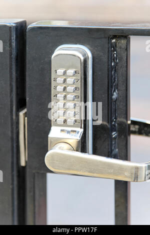 Electronic lock with pin code at fence Stock Photo