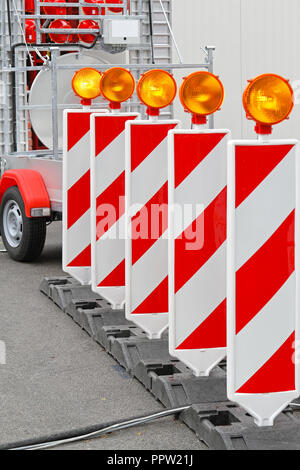 Road barrier with amber beacon flashing lights Stock Photo