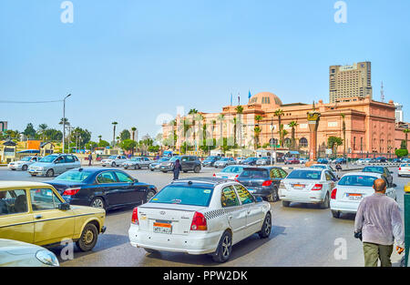 CAIRO, EGYPT - DECEMBER 23, 2017: The rush time in Midan Tahrir square with beautiful Egyptian Museum building on the background, on December 23 in Ca Stock Photo