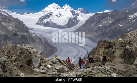 Aletsch Glacier, Switzerland – June 24, 2011: Tourists have come to see the Great Aletsch Glacier. It is the largest glacier in the Alps Stock Photo