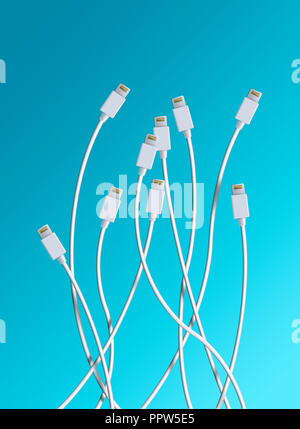 White Cables with iPhone iPad Charging Connection Plugs Stock Photo