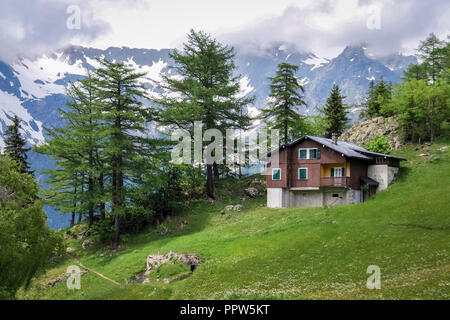 Forclaz, Switzerland – June 25, 2013: Old Chalet on a rainy day near the mountain pass Col de la Forclaz in the Swiss canton of Valais. Stock Photo