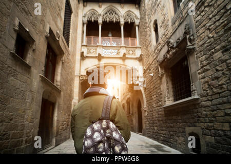 Young traveler man with backpack sightseeing in Barcelona Barri Gothic Quarter and Bridge of Sighs in Barcelona, Catalonia, Spain. Stock Photo