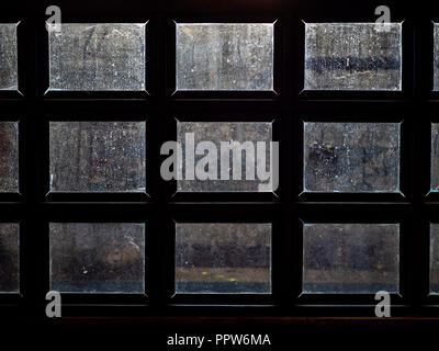 Dirty window glass with the light from outside. Water stain on the sheet glass. Stock Photo