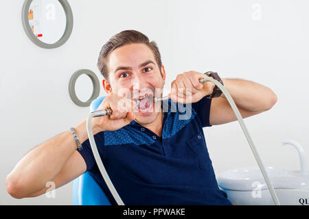 Crazy patient sitting in a dental chair Stock Photo