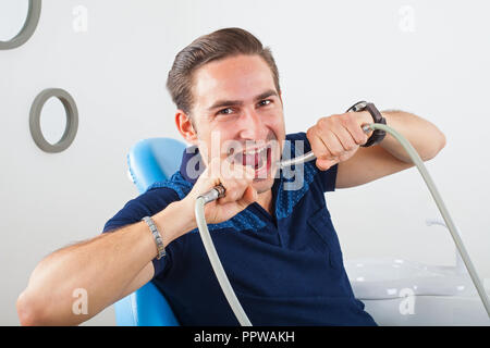 Crazy patient sitting in a dental chair Stock Photo