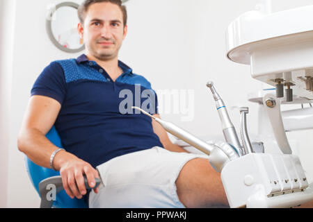 Crazy patient sitting in a dental chair Stock Photo