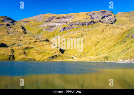 Encountering Bachalpsee during the famous hiking trail from First to Grindelwald (Bernese Alps, Switzerland). Stock Photo