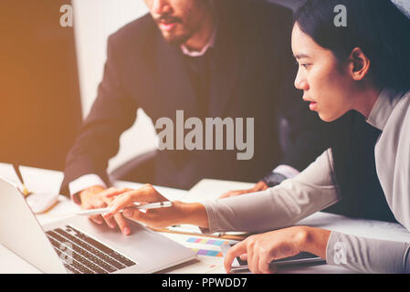 Business meeting time. Photo young account managers crew working with new startup project. Notebook on wood table. Idea presentation, analyze plans Stock Photo