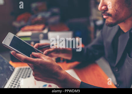 Businessmen are analyzed data from report using smartphone and laptop computer. Stock Photo