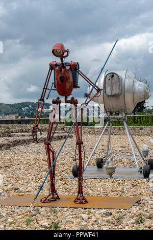 Contemporary art installation of a red robot and spacecraft scanning earth surface in Budapest, Hungary Stock Photo