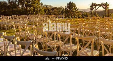Rows and columns of chairs facing a Chuppah Stock Photo