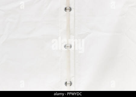 Closeup of white tarpaulin made of waterproof material with wire or rope as detail of truck Stock Photo