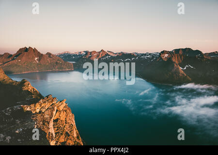 Sunset mountains over sea landscape in Norway aerial view Travel vacations breathtaking scenery Senja islands Stock Photo