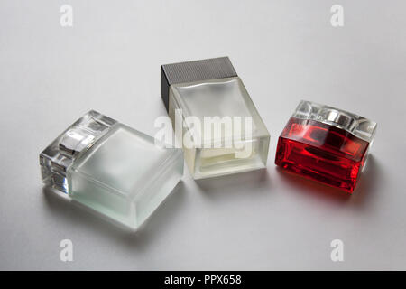 Three rectangular glass perfume bottles isolated on white background Stock Photo