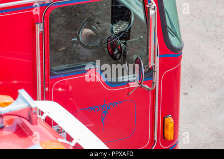 Partial view of a red and blue painted Western Star and Kenworth semi trailer, prime mover heavy truck from above Stock Photo