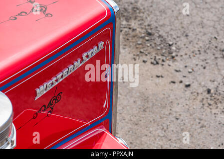 Partial view of the front of a red and blue painted Western Star semi trailer, prime mover heavy truck from above Stock Photo